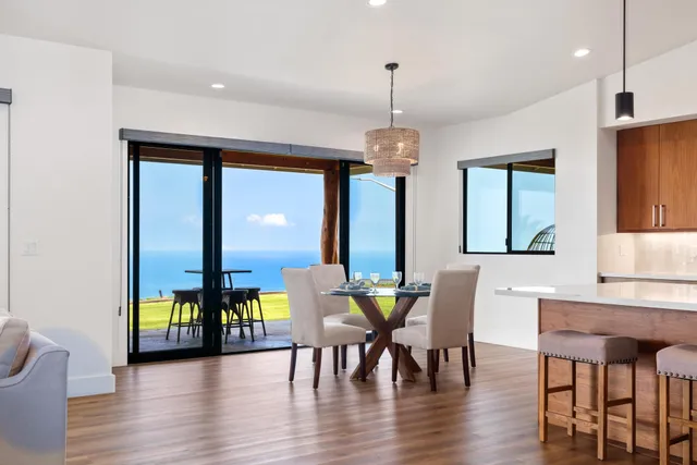 a living room with furniture and floor to ceiling windows