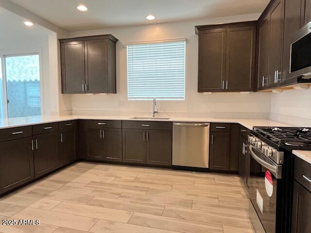 3341 South Lotus Mesa, AZ 85212 - Photo 10 of 42 a kitchen with stainless steel appliances granite countertop a stove a sink and a microwave