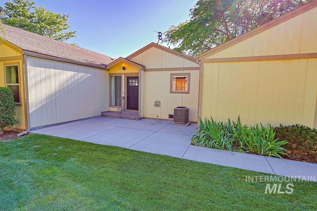 640 Morrison Street Twin Falls, ID 83301 - Photo 1 of 30 Exterior featuring a covered entryway, a dark wood-finish door with glass inserts, and light yellow siding