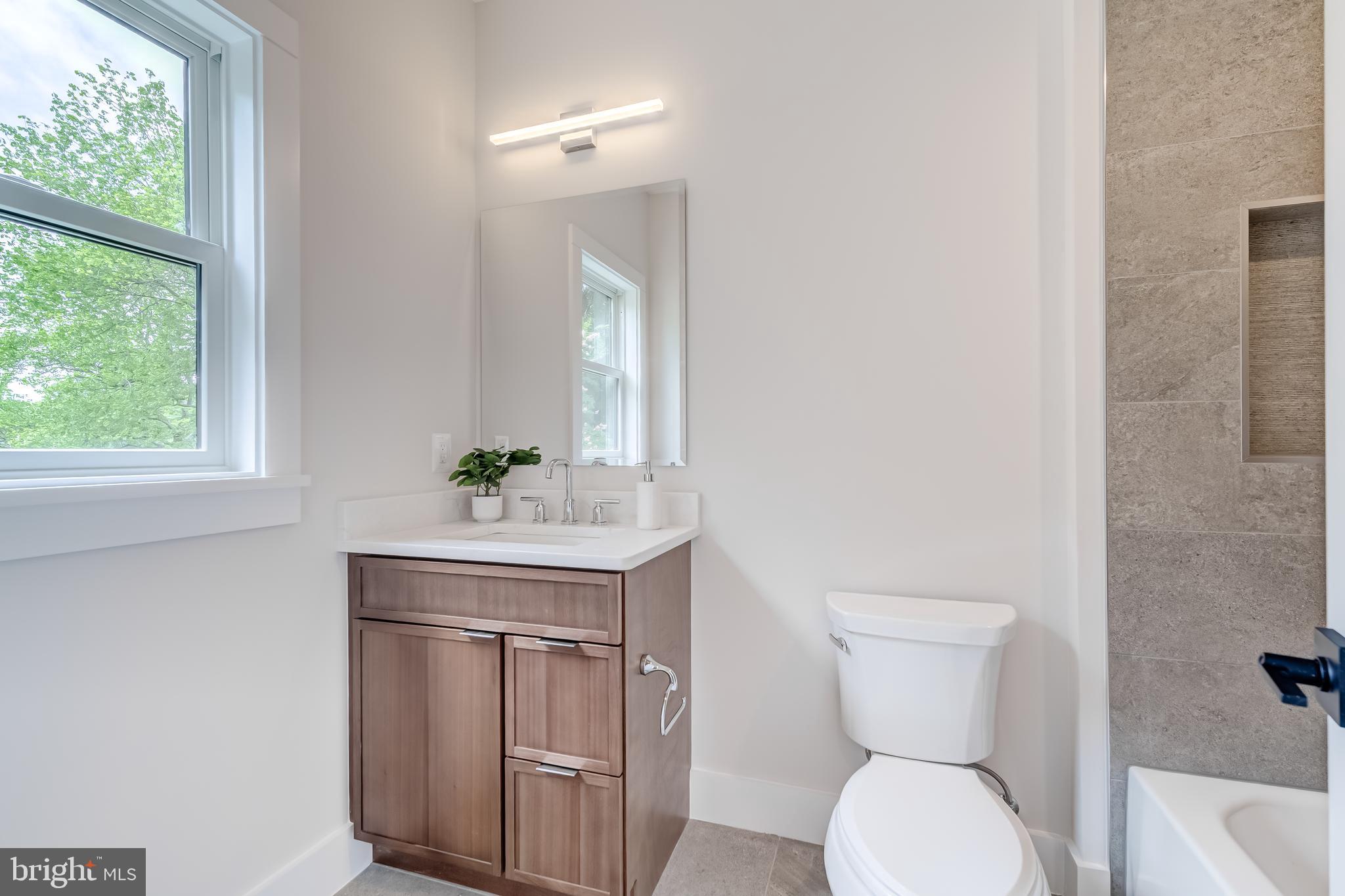 506 Kingsley Road Southwest Vienna, VA 22180 - Photo 103 of 150 a bathroom with a toilet a sink and a window
