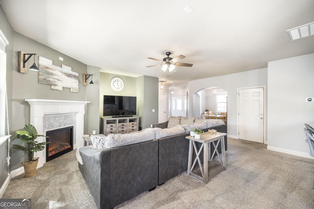 400 Ansley Avenue Perry, GA 31069 - Photo 11 of 37 a living room with furniture a fireplace and a flat screen tv
