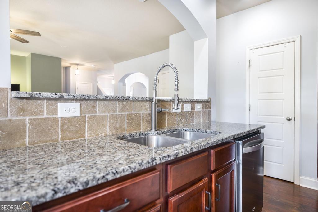 400 Ansley Avenue Perry, GA 31069 - Photo 15 of 37 a kitchen with granite countertop a sink and a wooden floor