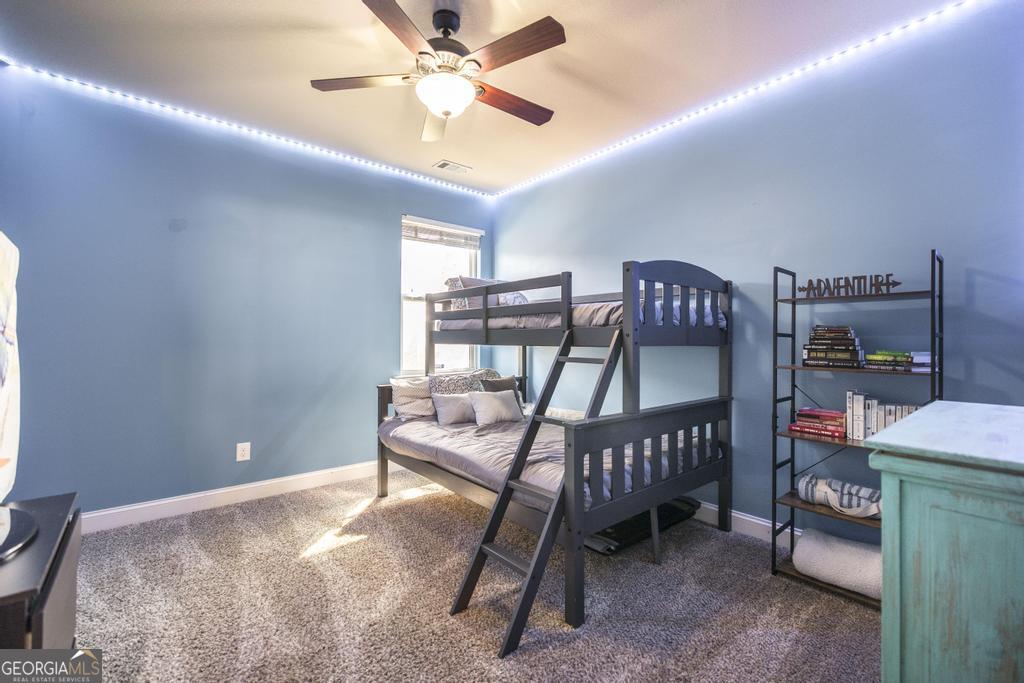 400 Ansley Avenue Perry, GA 31069 - Photo 18 of 37 a bedroom with a bed and a chandelier