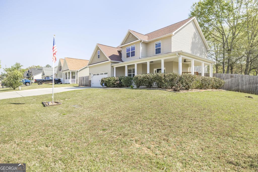 400 Ansley Avenue Perry, GA 31069 - Photo 2 of 37 a front view of a house with a yard