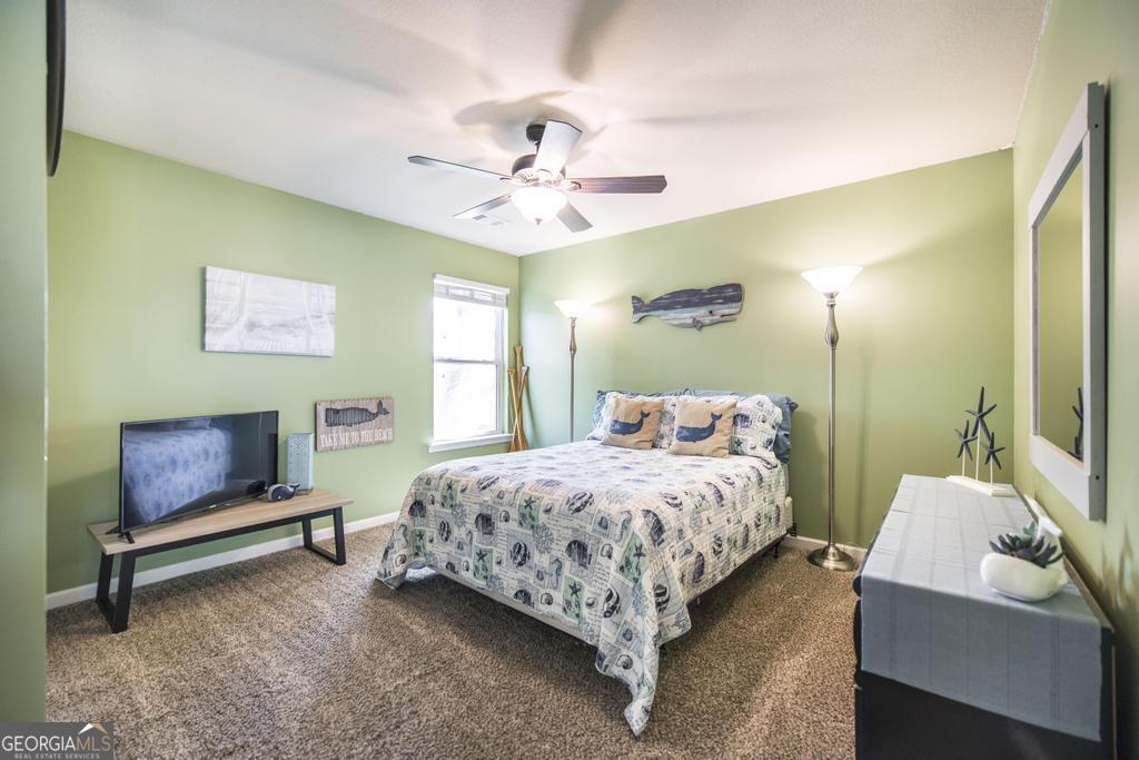 400 Ansley Avenue Perry, GA 31069 - Photo 24 of 37 a bedroom with a bed and a chandelier