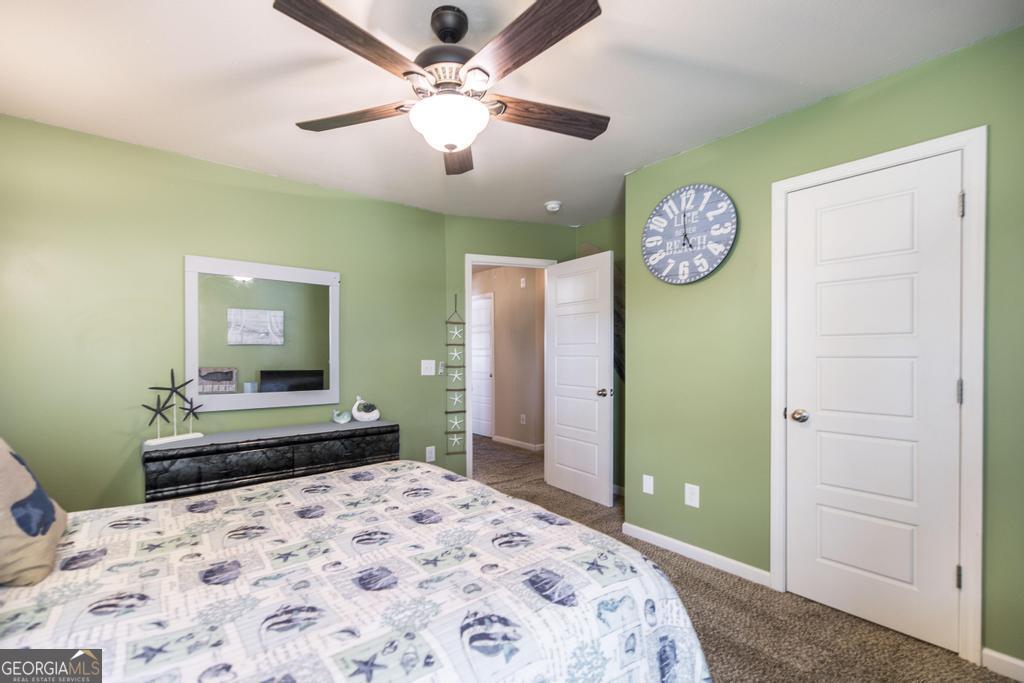 400 Ansley Avenue Perry, GA 31069 - Photo 25 of 37 a bedroom with a bed and a chandelier