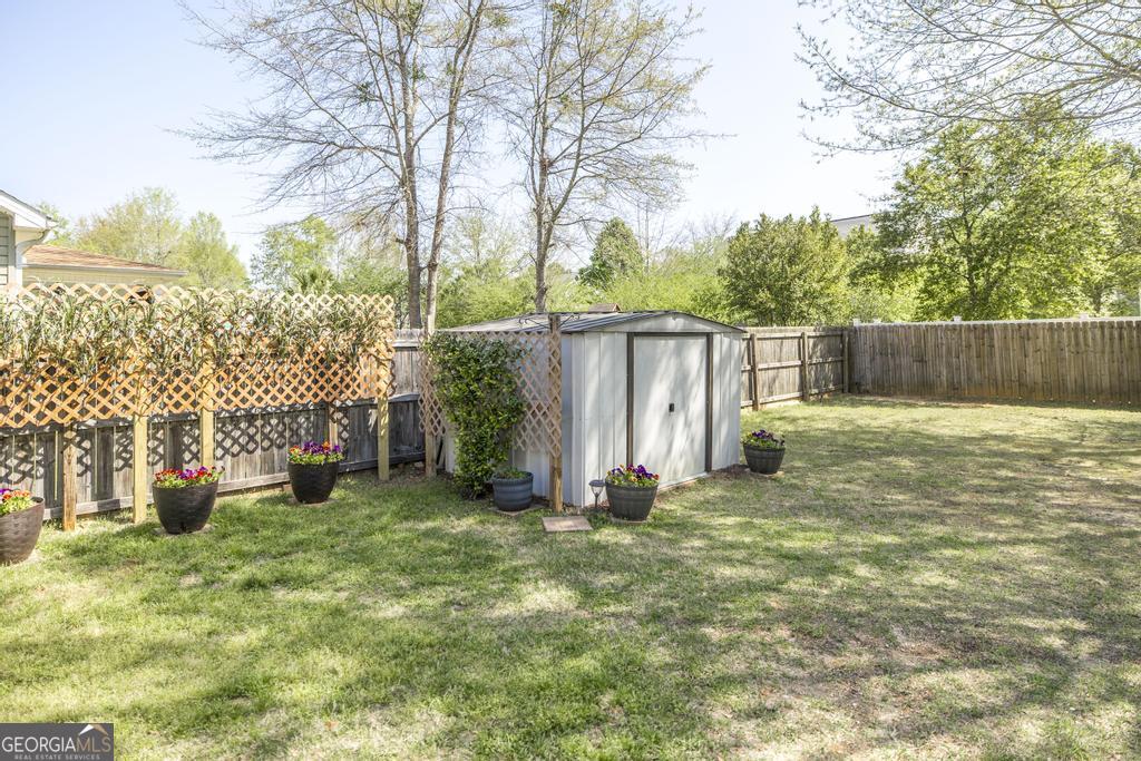 400 Ansley Avenue Perry, GA 31069 - Photo 37 of 37 a view of a backyard with large tree and wooden fence