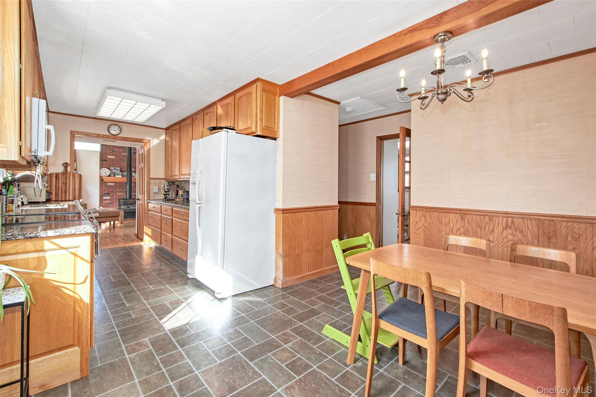 22 Ridgeland Terrace Rye, NY 10580 - Photo 15 of 19 a dining room with furniture and a chandelier