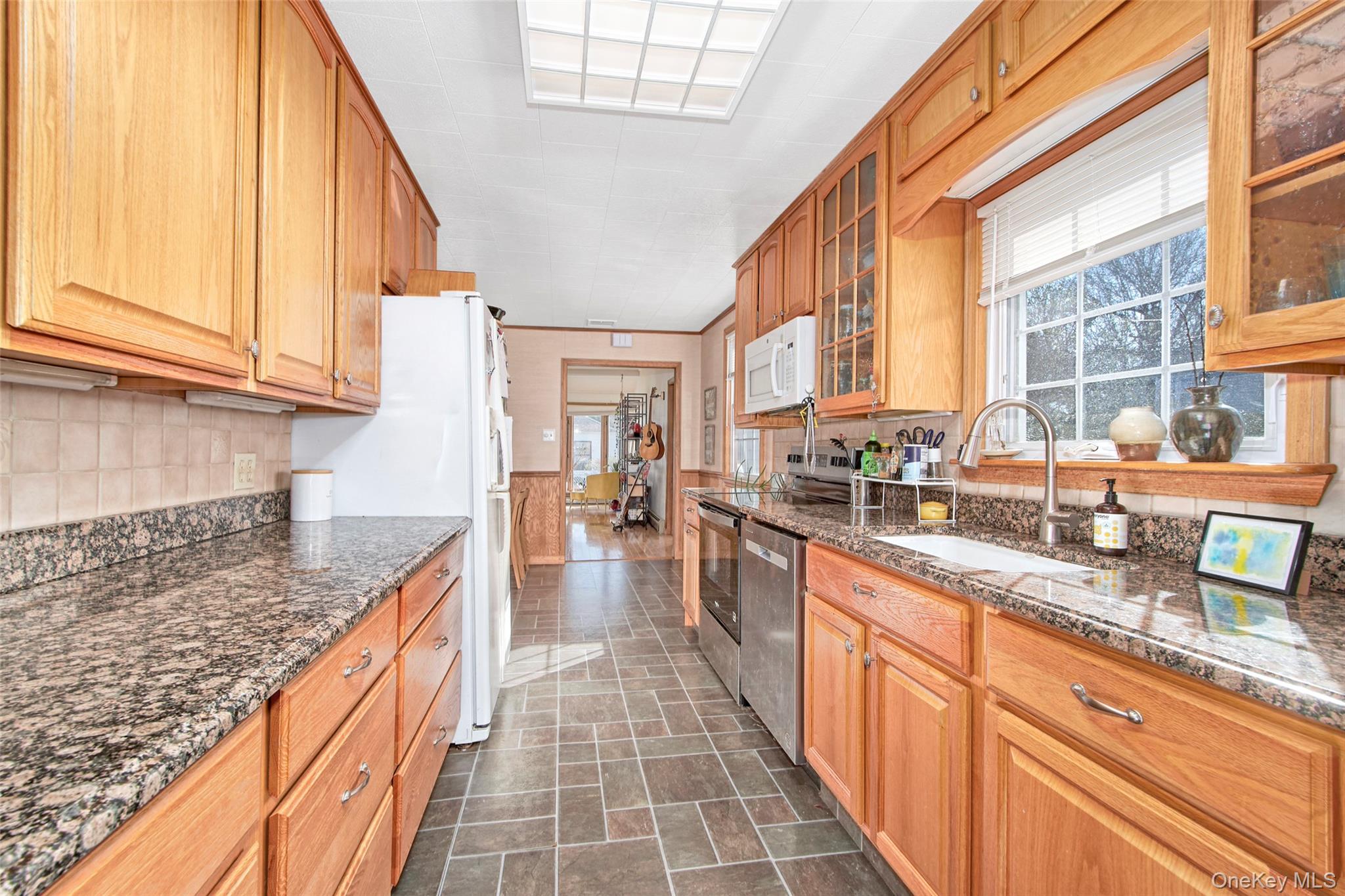 22 Ridgeland Terrace Rye, NY 10580 - Photo 17 of 19 a large kitchen with granite countertop a sink and dishwasher stove top oven