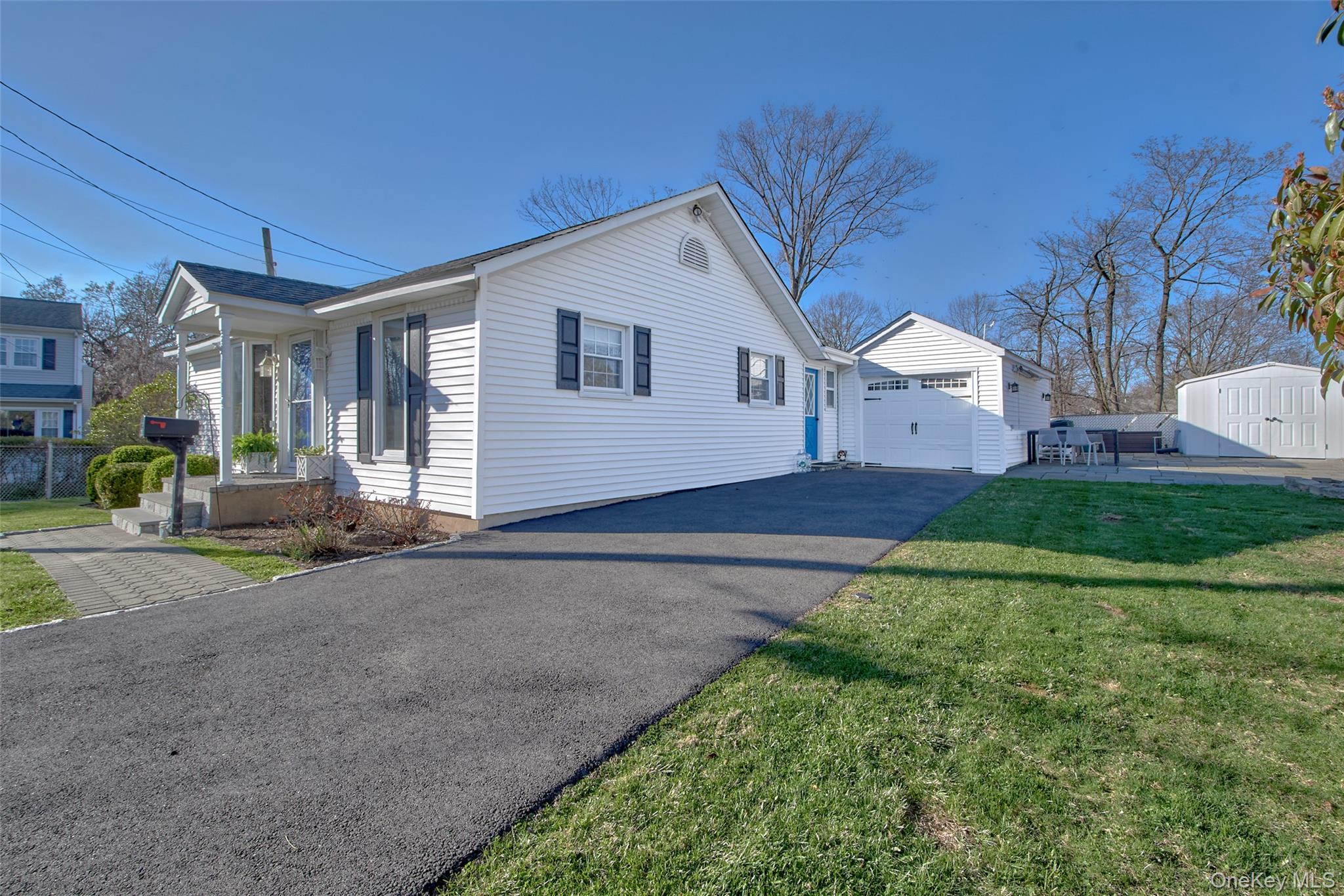 22 Ridgeland Terrace Rye, NY 10580 - Photo 3 of 19 a view of a white house next to a yard and road