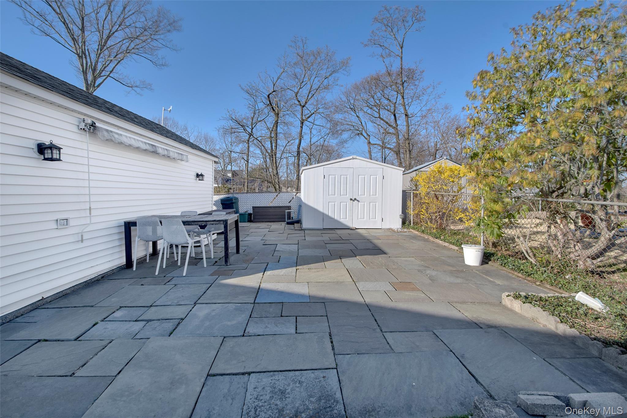 22 Ridgeland Terrace Rye, NY 10580 - Photo 4 of 19 a view of a backyard with table and chairs and potted plants