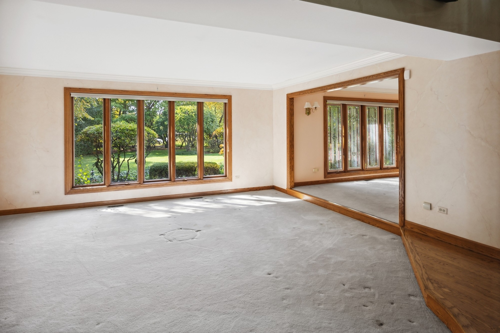 989 South Ridge Road Lake Forest, IL 60045 - Photo 12 of 36 an empty room with floor to ceiling windows and an outdoor space