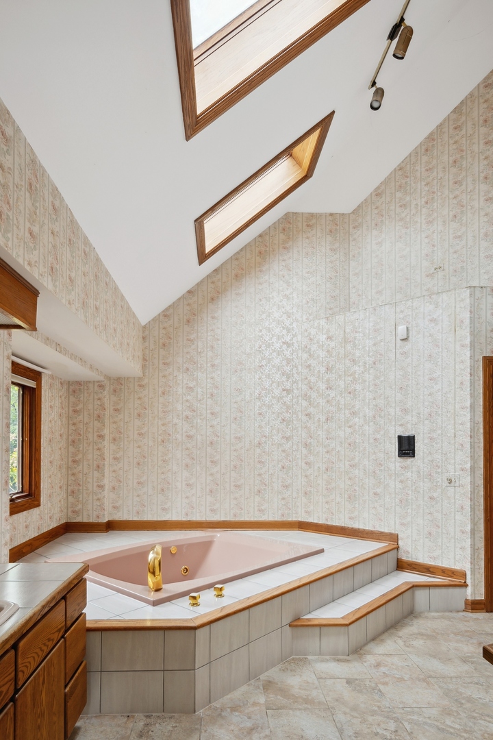 989 South Ridge Road Lake Forest, IL 60045 - Photo 24 of 36 a bathroom with a tub and a shower
