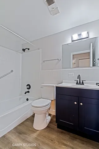 a bathroom with a sink toilet a mirror and shower