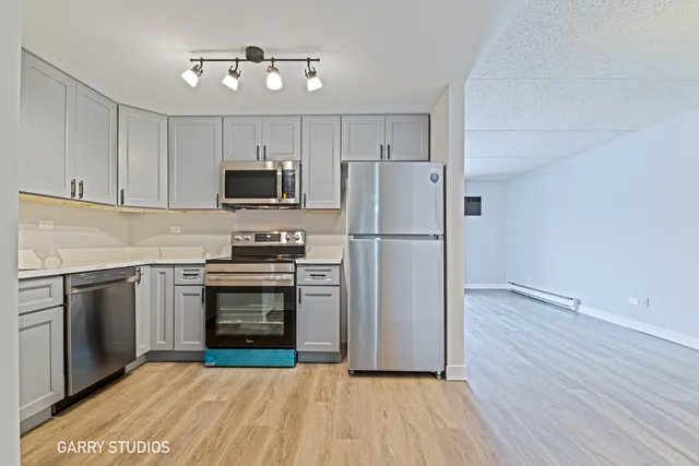 a kitchen with a refrigerator and a stove