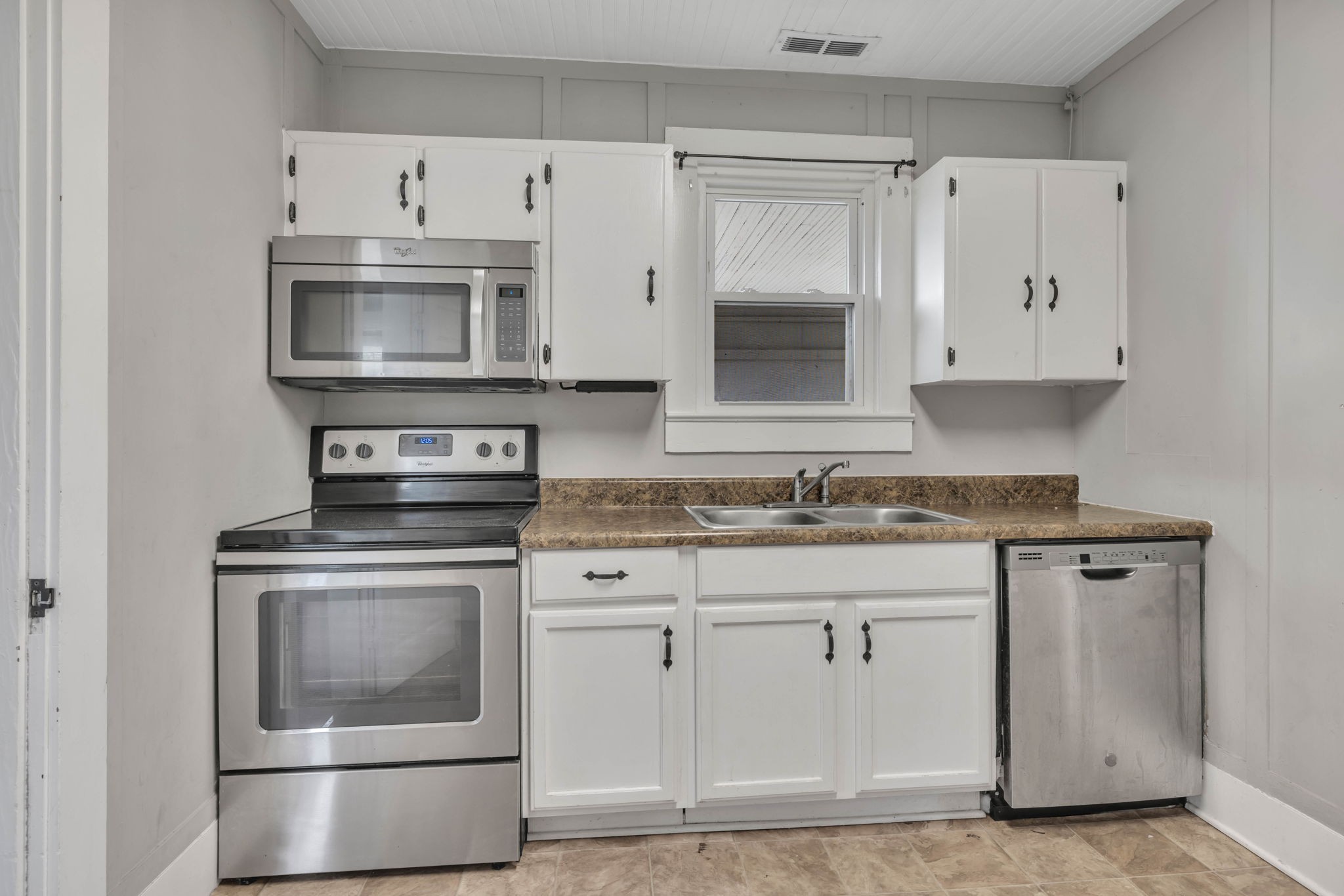 301 Maple Street Chapel Hill, TN 37034 - Photo 20 of 38 a kitchen with white cabinets and stainless steel appliances
