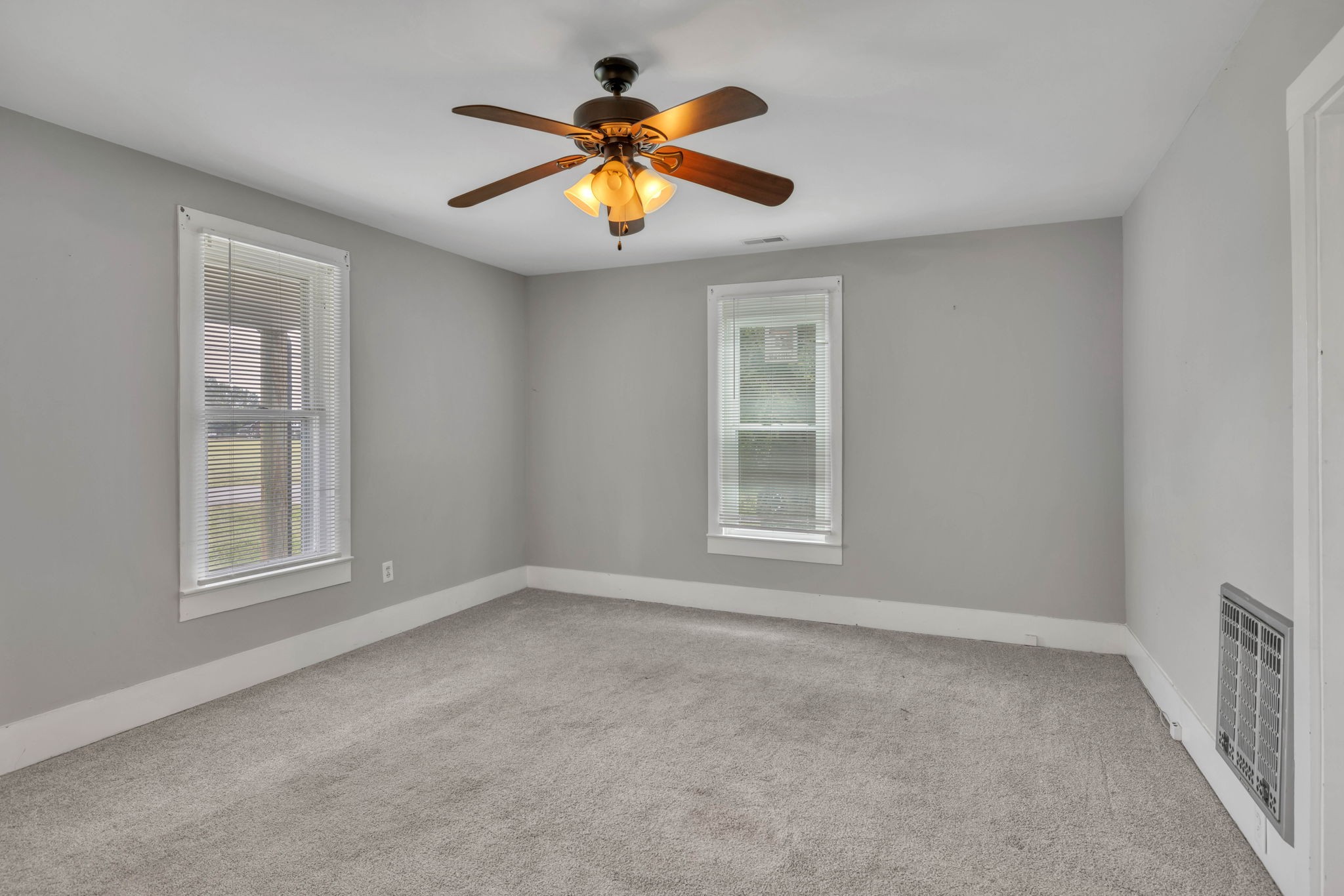 301 Maple Street Chapel Hill, TN 37034 - Photo 10 of 38 an empty room with windows and chandelier fan