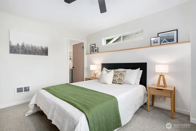 a bedroom with a large bed and a window