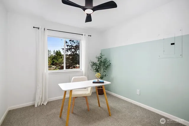 a view of a room that has a table and chair in it