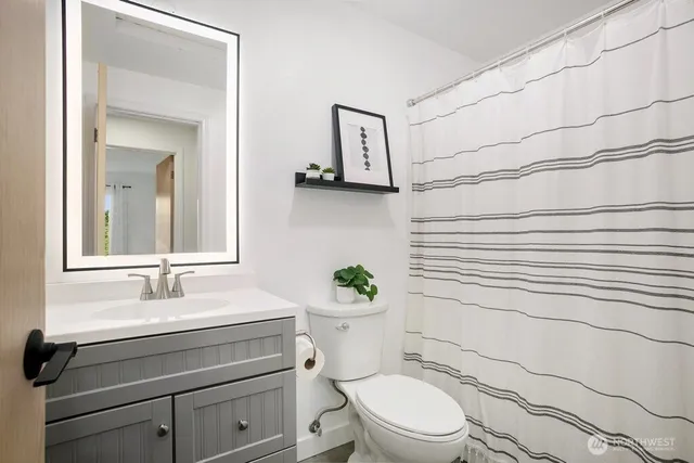 a utility room with stainless steel appliances washer and dryer