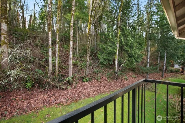 a white building with a large window and large tree