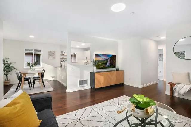 a living room with furniture and a wooden floor