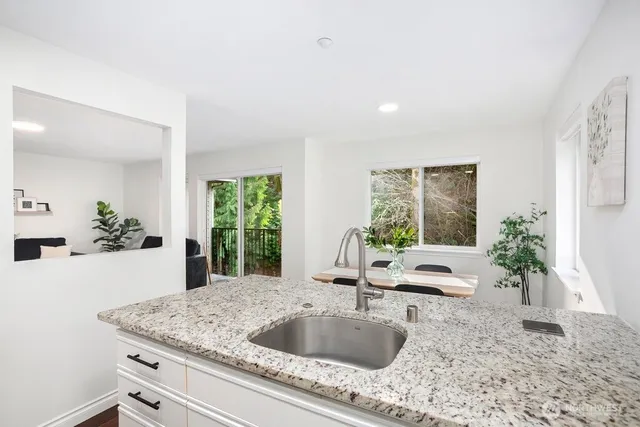 a kitchen with a stove a sink and a refrigerator