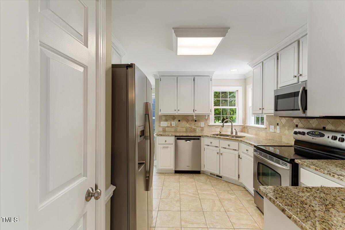 2408 Dahlgreen Road Raleigh, NC 27615 - Photo 15 of 61 a kitchen with a sink stove and refrigerator