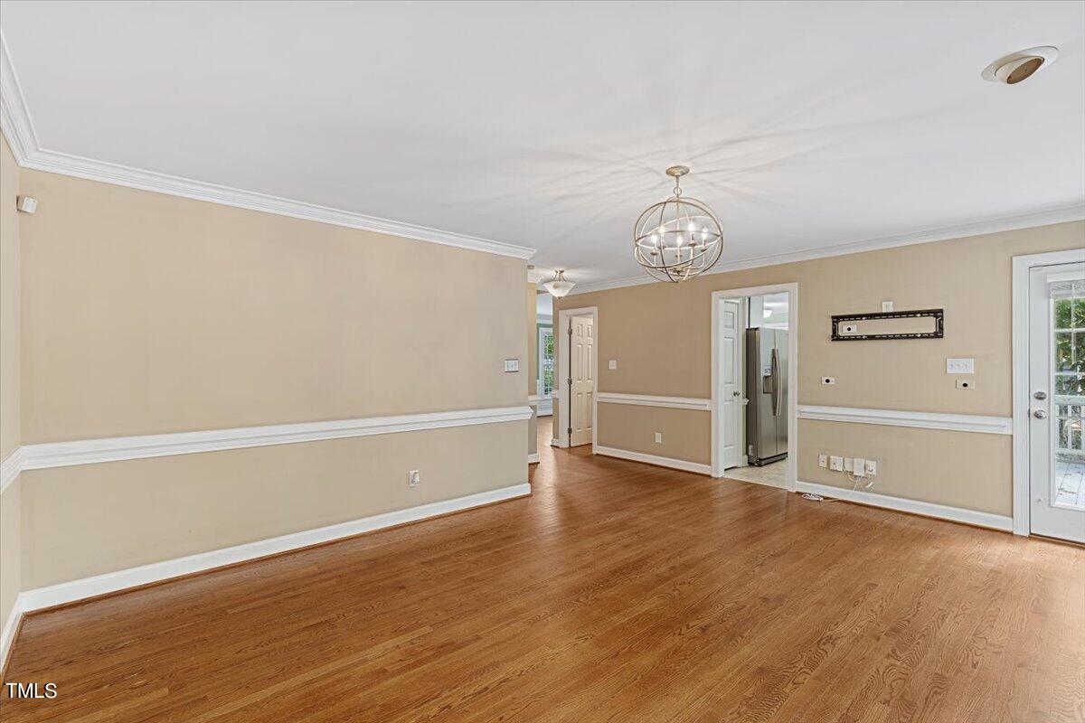 2408 Dahlgreen Road Raleigh, NC 27615 - Photo 19 of 61 a view of an empty room with wooden floor and a window