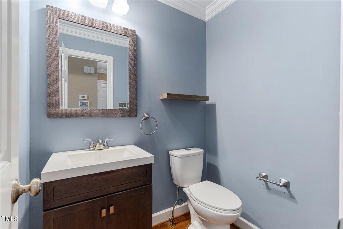 2408 Dahlgreen Road Raleigh, NC 27615 - Photo 22 of 61 a bathroom with a toilet sink and mirror