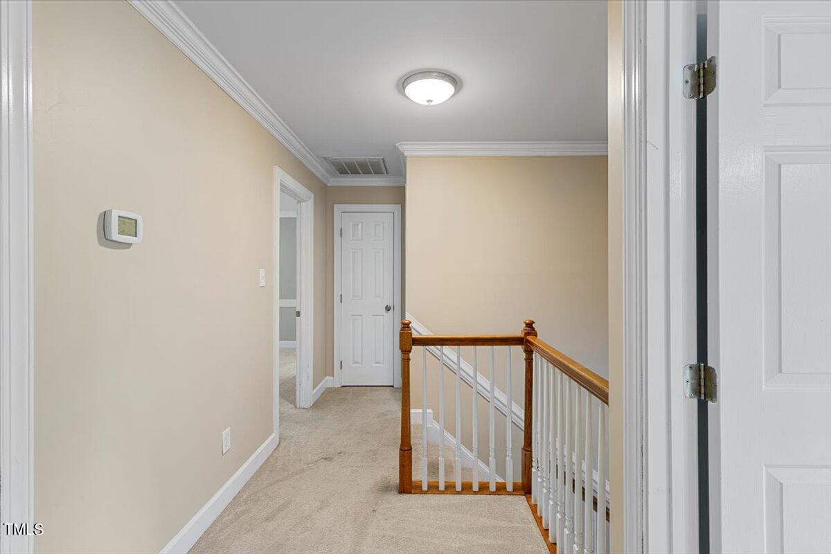 2408 Dahlgreen Road Raleigh, NC 27615 - Photo 25 of 61 a view of a hallway with a door and stairs