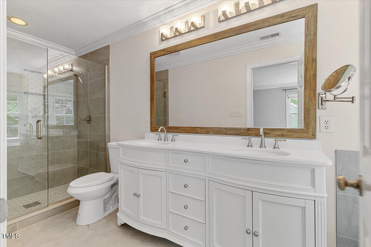 2408 Dahlgreen Road Raleigh, NC 27615 - Photo 42 of 61 a bathroom with a double vanity sink mirror and toilet