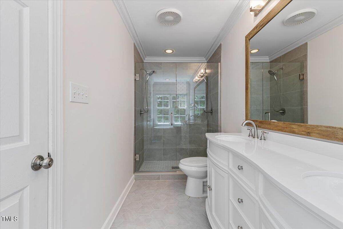 2408 Dahlgreen Road Raleigh, NC 27615 - Photo 44 of 61 a bathroom with a double vanity sink toilet mirror and shower