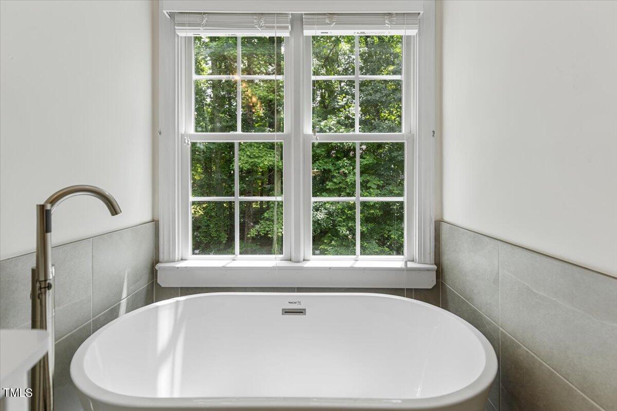 2408 Dahlgreen Road Raleigh, NC 27615 - Photo 45 of 61 a white bath tub sitting next to a window