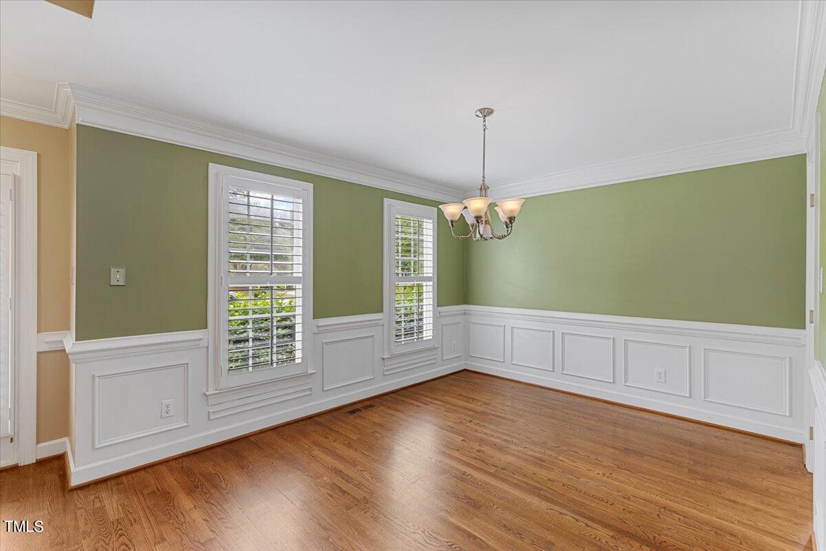 2408 Dahlgreen Road Raleigh, NC 27615 - Photo 6 of 61 a view of an empty room with wooden floor and a window