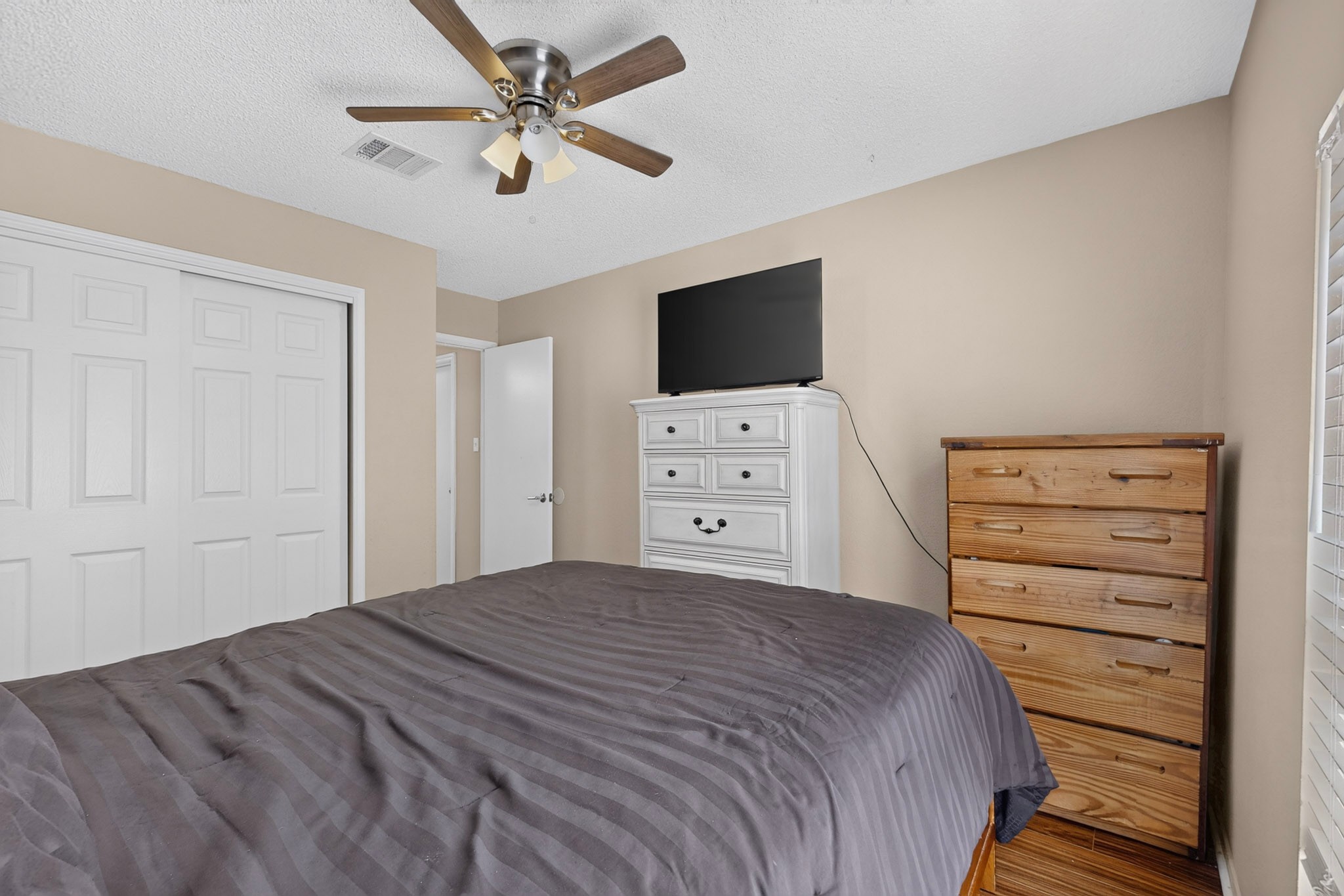 1601 Rusty Nail Loop Round Rock, TX 78681 - Photo 15 of 23 Laminate floors complement the neutral walls and built-in sliding closet doors in this cozy bedroom.