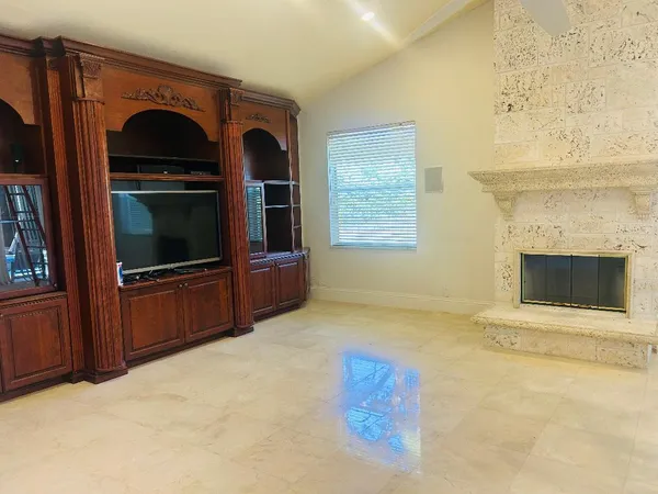 a living room with a fireplace and a television