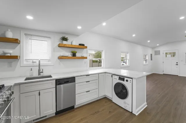 a kitchen with a sink a washer and dryer