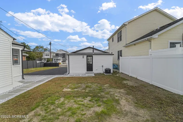 a view of yellow house with a yard