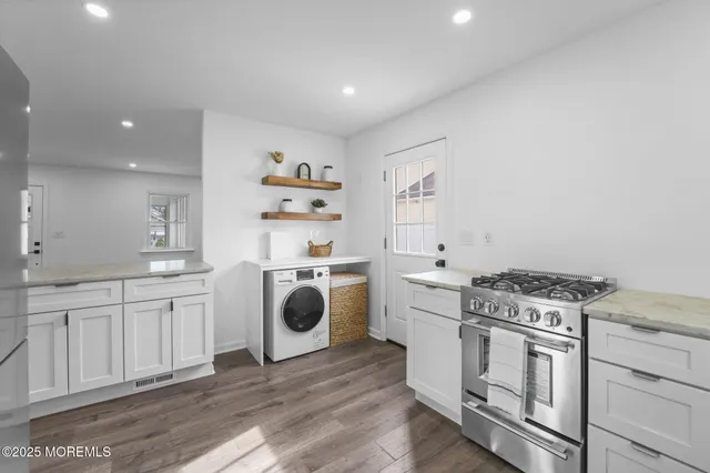 a kitchen with a stove top oven sink and cabinets