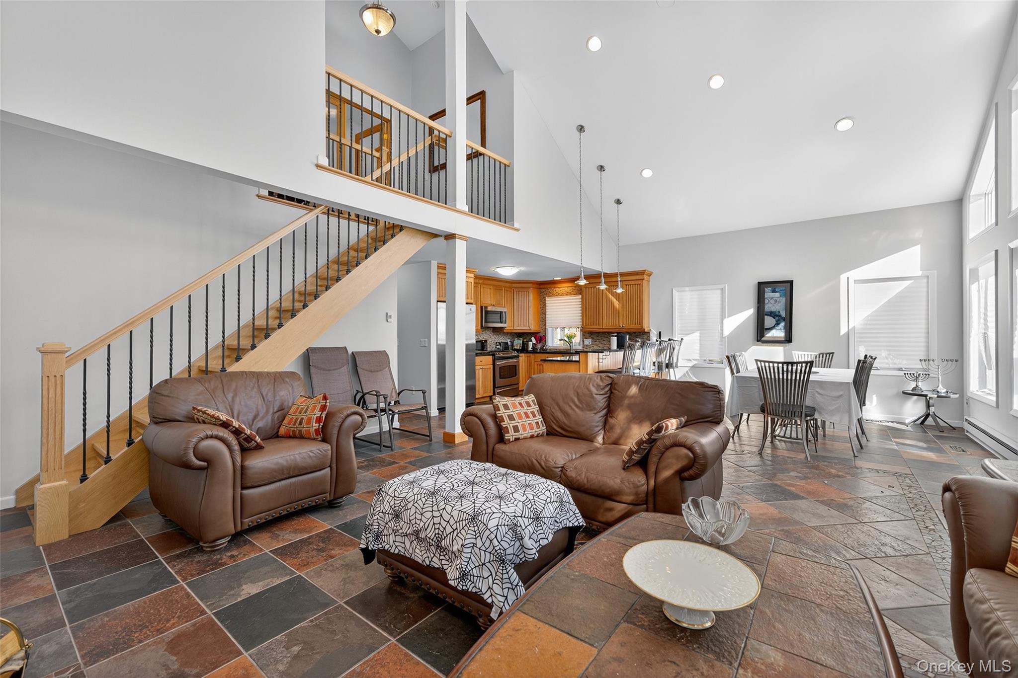 518 Sackett Lake Road Monticello, NY 12701 - Photo 16 of 44 a living room with furniture kitchen view and a dining table