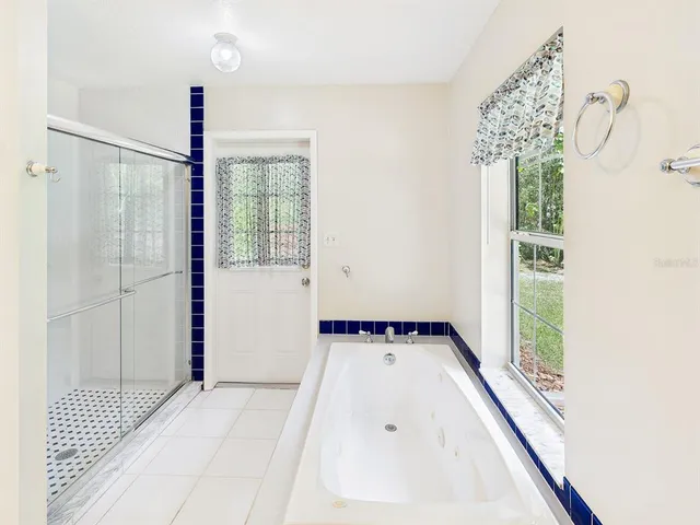 a view of an empty room with closet and a window