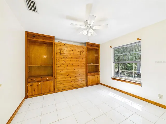 an empty room with windows and closet