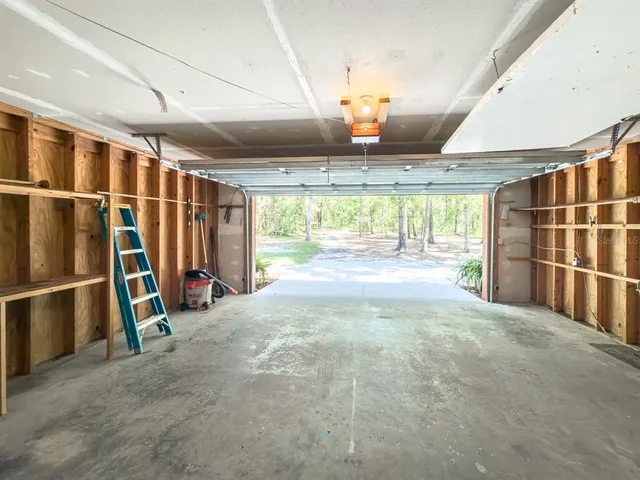 a view of a patio with a table chairs and wooden floor