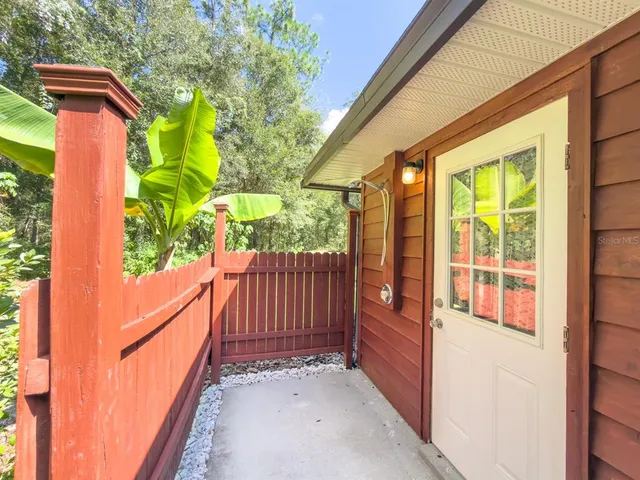 a view of a patio with table and chairs and wooden floor