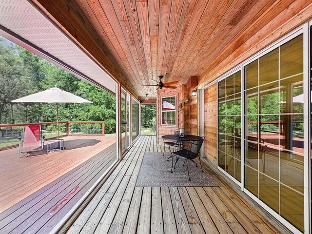 a view of balcony with wooden floor and outdoor seating