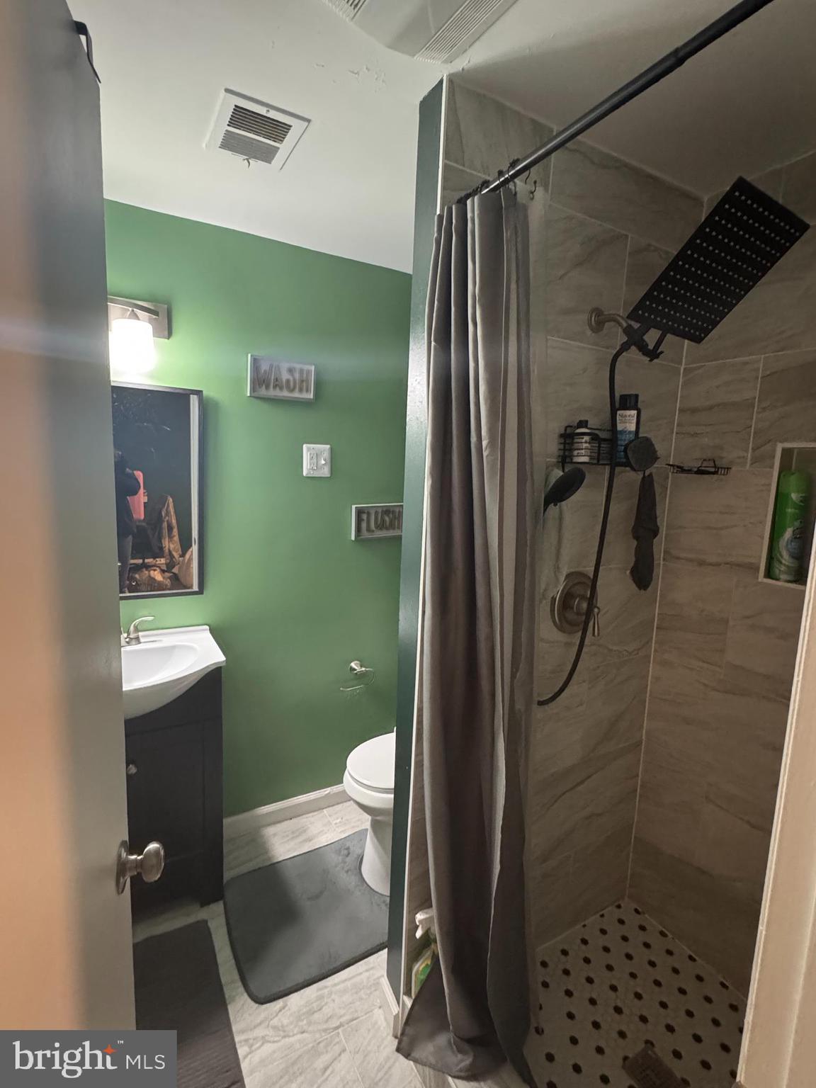 1508 Nicholas Road Waldorf, MD 20601 - Photo 26 of 36 a bathroom with a shower toilet and sink