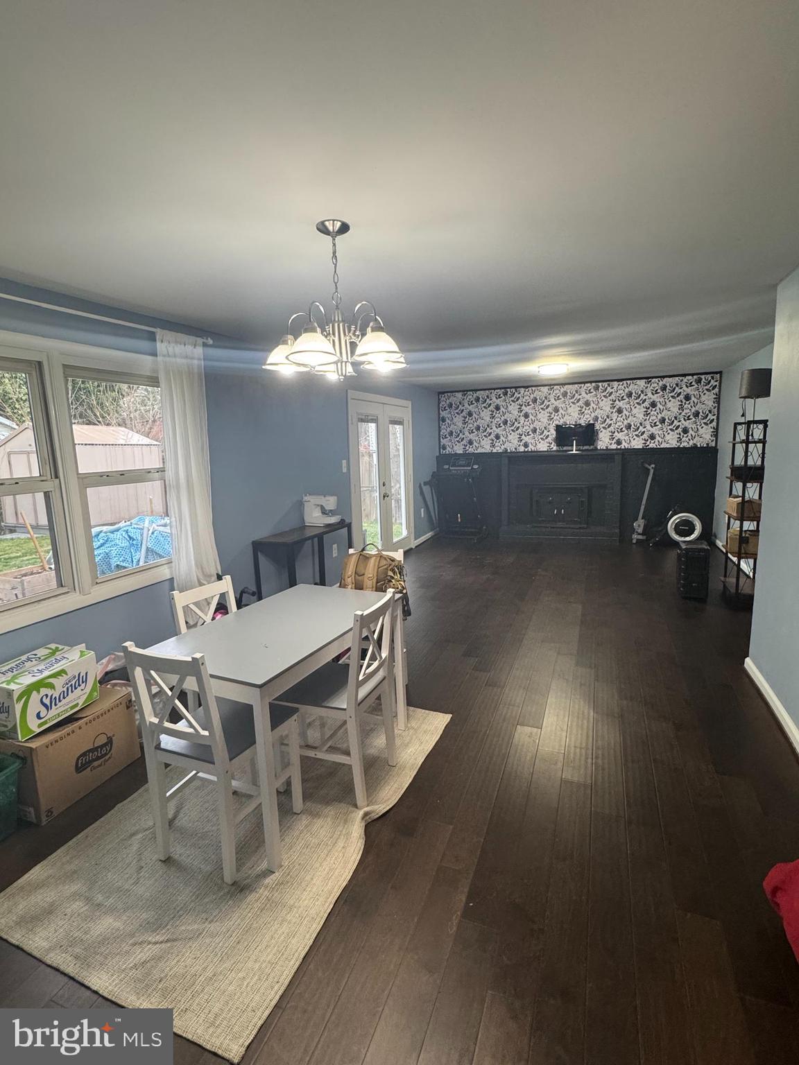 1508 Nicholas Road Waldorf, MD 20601 - Photo 7 of 36 a dining room with wooden floor a chandelier a glass table and chairs