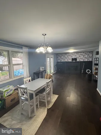 a view of a dining room with furniture wooden floor and chandelier