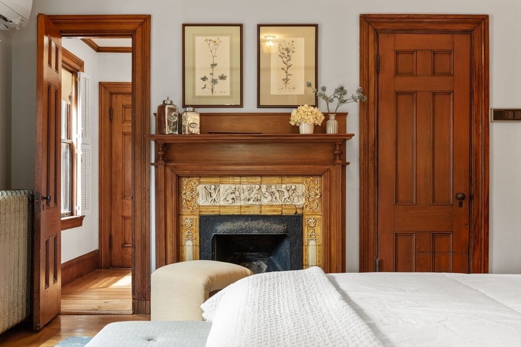 35 Langdon Street Cambridge, MA 02138 - Photo 25 of 35 a bedroom with a bed and a fireplace